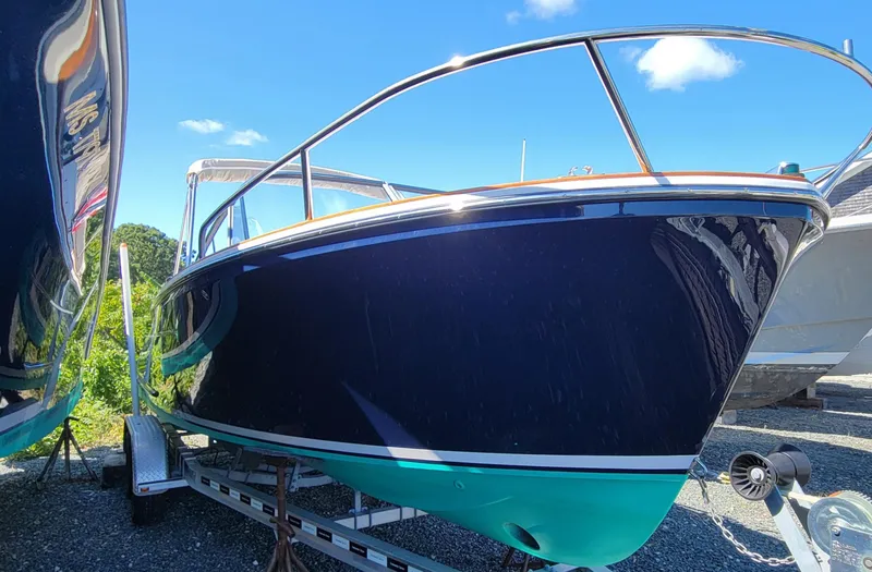 Slide: The Image of 2017 Vanquish Runabout boat on trailer under clear blue sky. - 7
