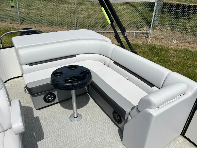Slide: The Image of 2023 Godfrey Sweetwater 2486 C pontoon boat seating area with table and cup holders. - 13