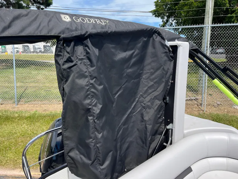 Slide: The Image of 2023 Godfrey Sweetwater 2486 C boat with black canopy and side cover. - 15
