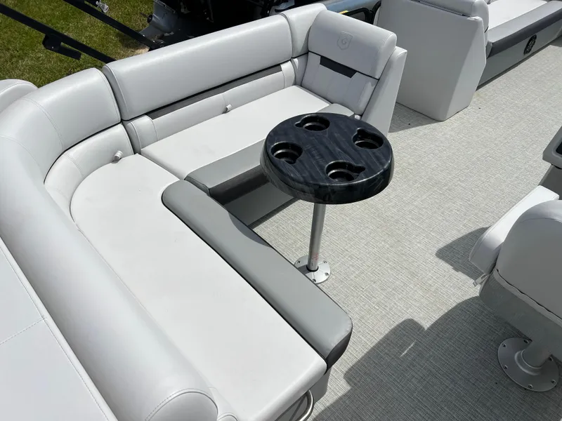 Slide: The Image of 2023 Godfrey Sweetwater 2486 C pontoon boat interior with gray seating and cup holder table. - 16