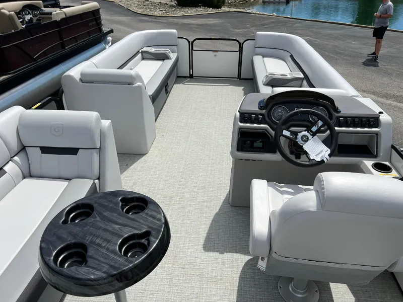 Slide: The Image of 2023 Godfrey Sweetwater 2486 C pontoon boat interior with white seating and steering console. - 17