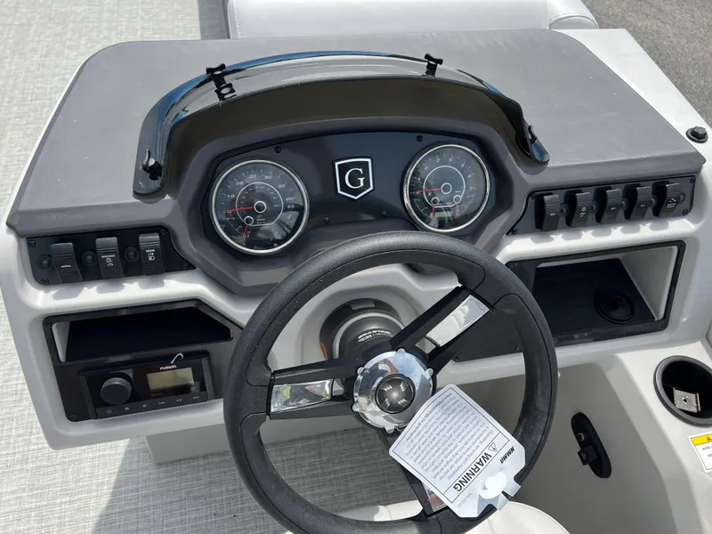 Slide: The Image of 2023 Godfrey Sweetwater 2486 C boat dashboard with steering wheel and instrument panel. - 19