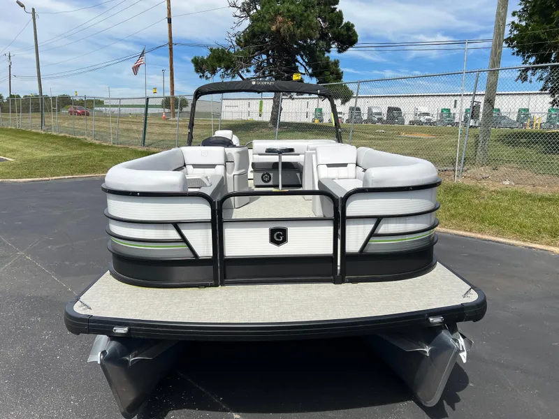 Slide: The Image of 2023 Godfrey Sweetwater 2486 C pontoon boat, front view, parked on pavement. - 4
