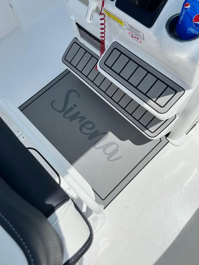 Slide: The Image of 2022 Tidewater 232 CC Adventure boat interior with "Sirena" mat and beverage holder. - 7