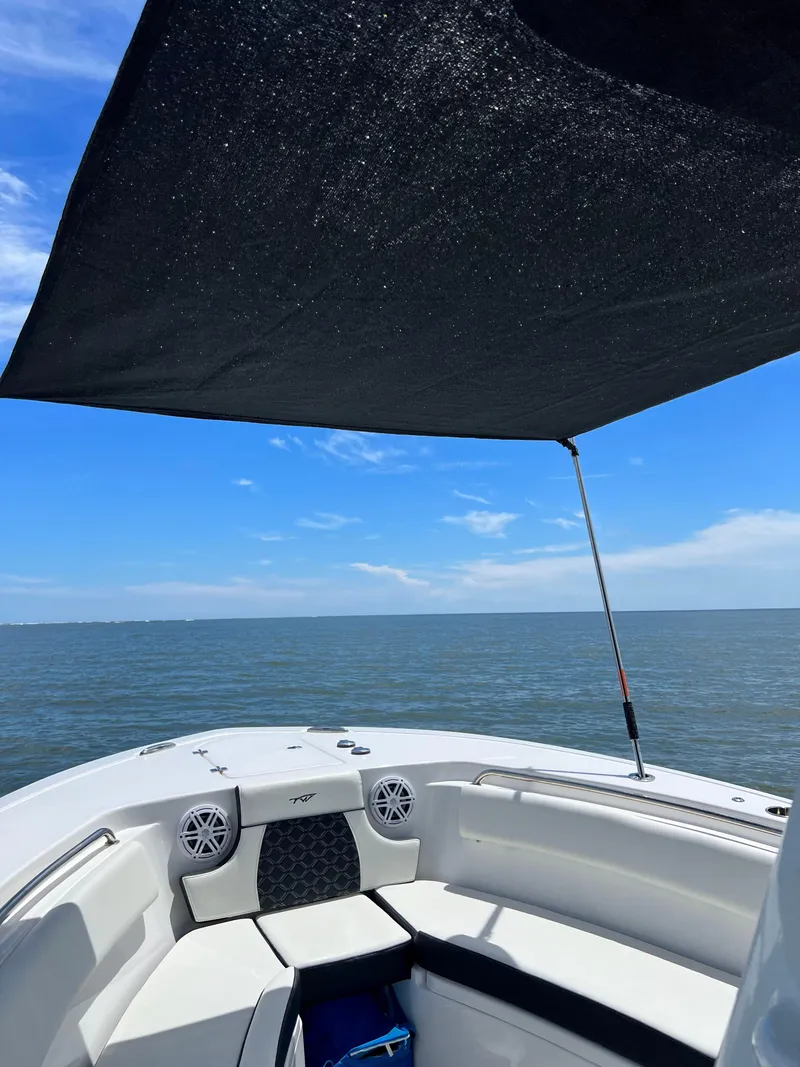 Slide: The Image of 2022 Tidewater 232 CC Adventure boat with sunshade on open water. - 8