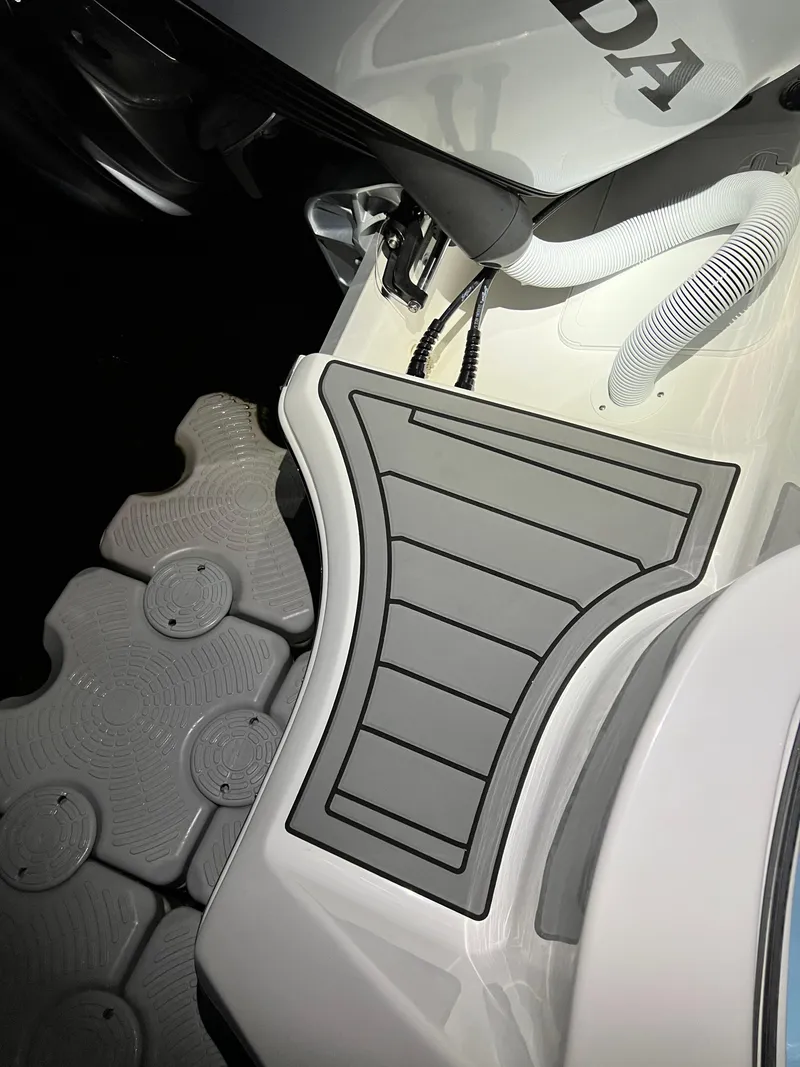 Slide: The Image of 2022 Tidewater 232 CC Adventure boat deck with Honda engine detail. - 9