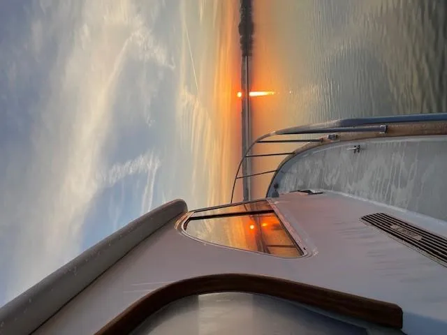 Slide: The Image of 2003 Legacy Yachts 34 Sedan at sunset on calm waters. - 22