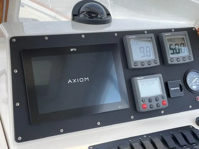 Slide: The Image of Control panel of 2003 Legacy Yachts 34 Sedan with Axiom display and navigation instruments. - 25