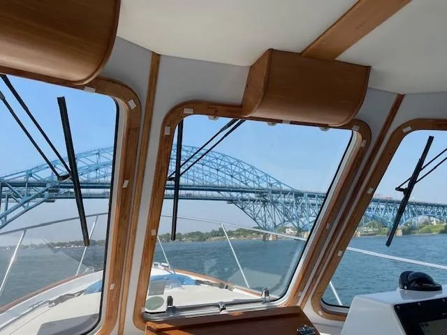 Slide: The Image of Interior view from 2003 Legacy Yachts 34 Sedan, overlooking a blue bridge on a sunny day. - 29