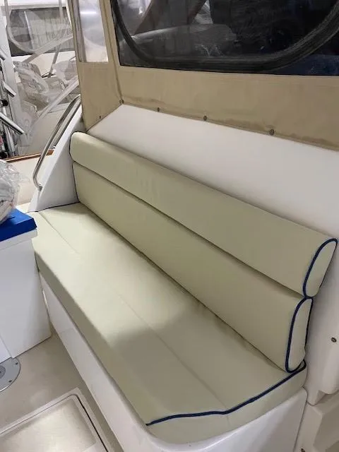 Slide: The Image of 2003 Legacy Yachts 34 Sedan interior with beige cushioned seating. - 32