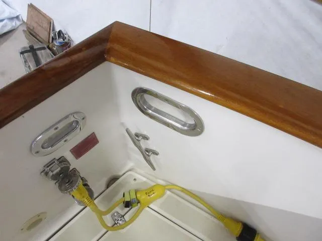 Slide: The Image of 2003 Legacy Yachts 34 Sedan boat deck with wooden trim and electrical connections. - 33