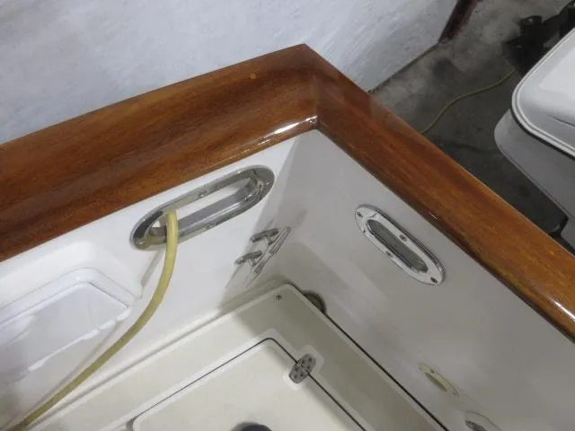 Slide: The Image of 2003 Legacy Yachts 34 Sedan, polished wooden trim and deck fittings. - 34