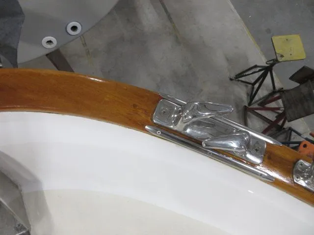 Slide: The Image of Close-up of 2003 Legacy Yachts 34 Sedan deck with polished wood and metal cleat. - 35