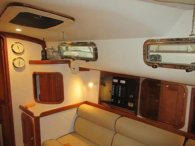 Slide: The Image of Interior of 2003 Legacy Yachts 34 Sedan with beige seating and wooden accents. - 45