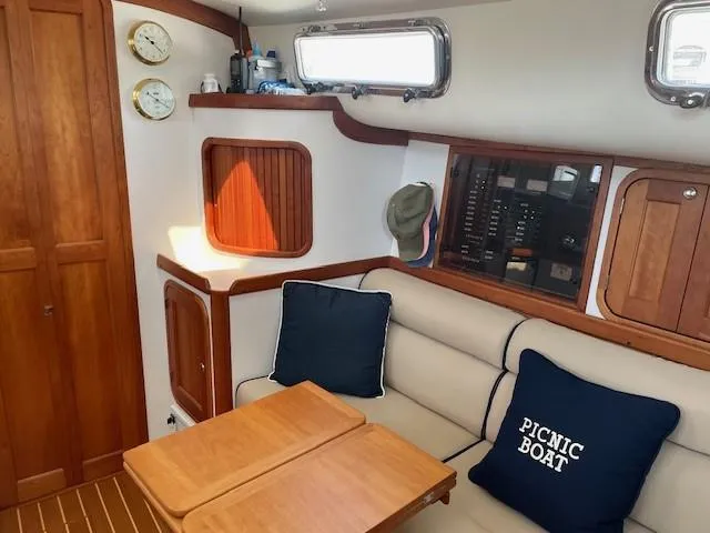 Slide: The Image of Interior of 2003 Legacy Yachts 34 Sedan with cozy seating and nautical decor. - 48
