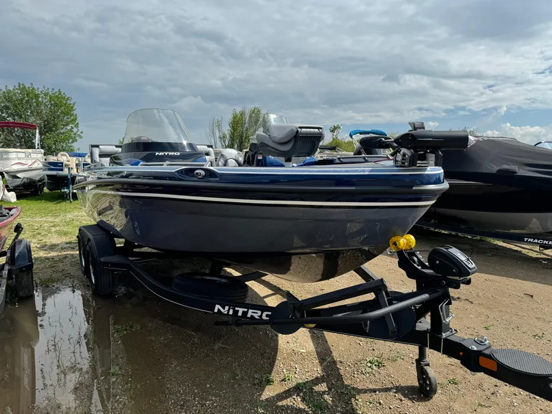 Slide: The Image of 2024 Nitro ZV19 Sport boat on trailer in outdoor setting. - 2