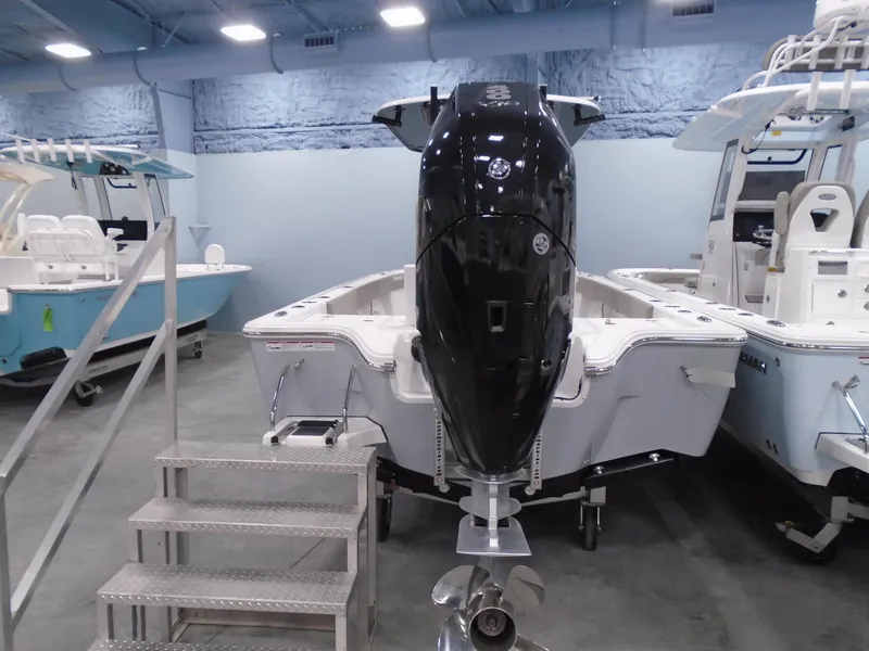 Slide: The Image of 2024 Sportsman 267OE boat with powerful outboard motor in showroom. - 1