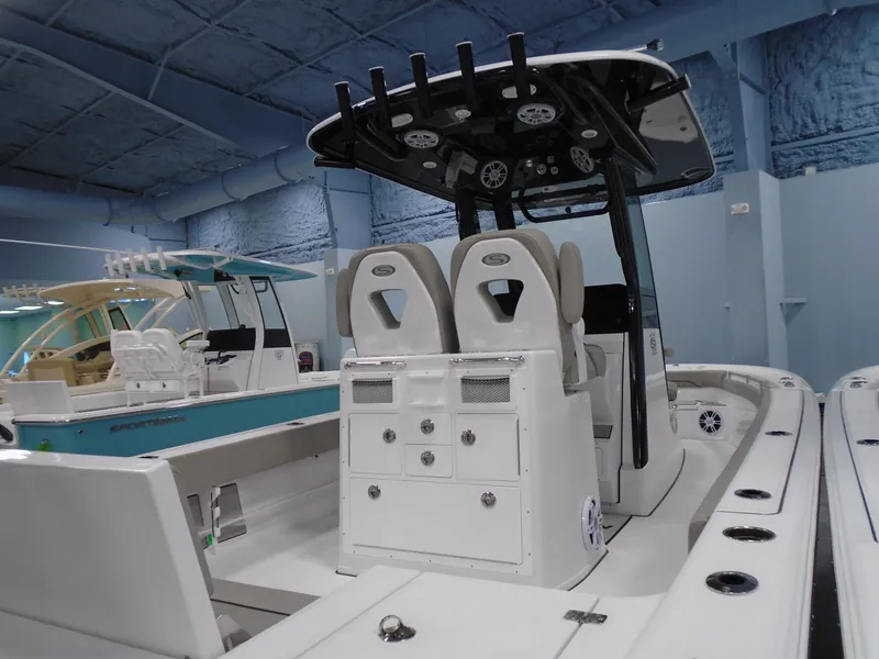 Slide: The Image of 2024 Sportsman 267OE boat interior with dual seats and control panel in showroom. - 11