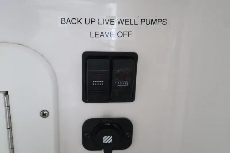Slide: The Image of Control panel for backup live well pumps on a 2016 Invincible 42 Open Fisherman. - 26