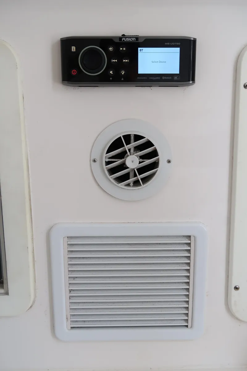 Slide: The Image of 2016 Invincible 42 Open Fisherman control panel with air vents and audio system. - 27