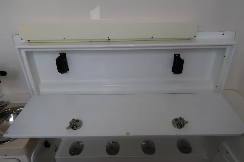 Slide: The Image of 2016 Invincible 42 Open Fisherman storage compartment with rod holders. - 29