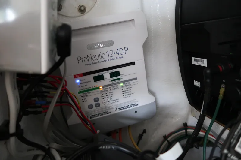 Slide: The Image of Battery charger and wiring inside a 2016 Invincible 42 Open Fisherman boat. - 33
