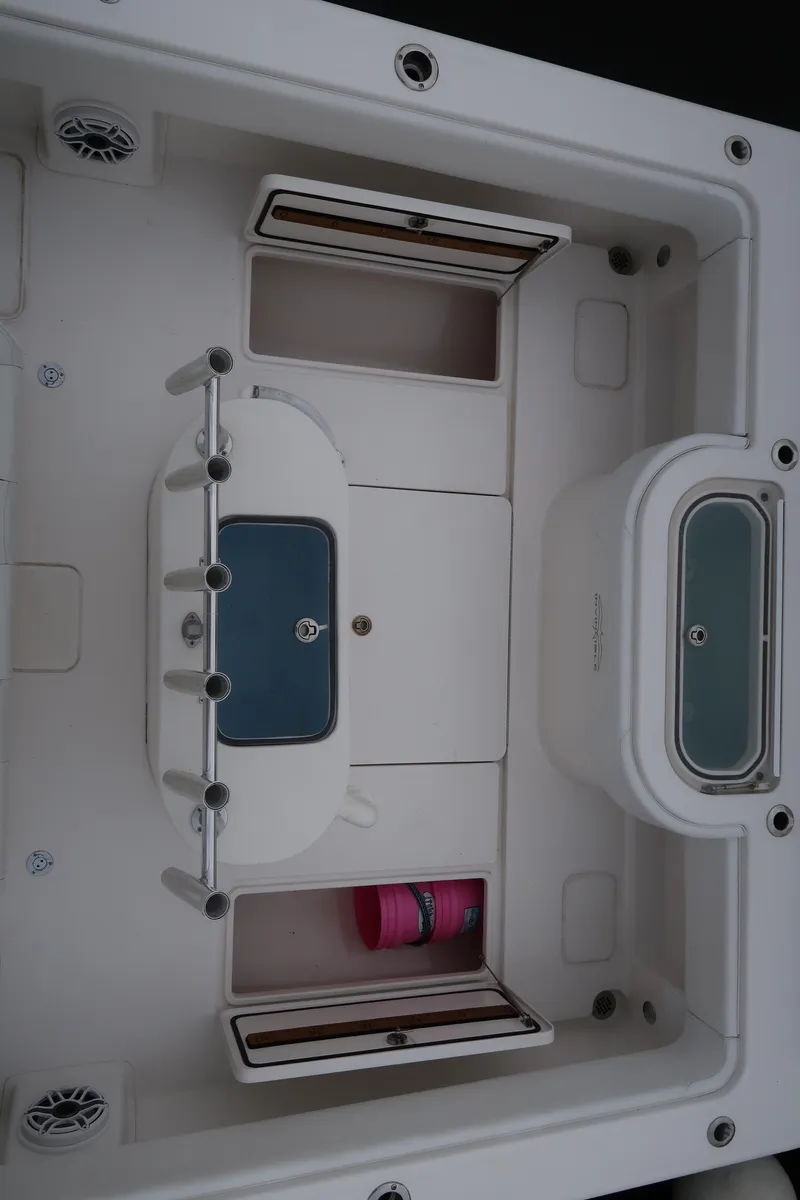 Slide: The Image of 2016 Invincible 42 Open Fisherman boat interior with storage compartments and rod holders. - 41