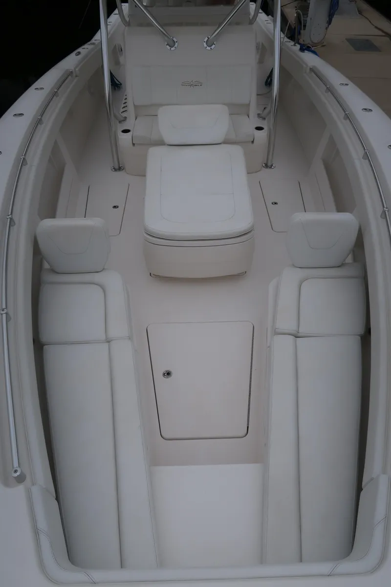 Slide: The Image of 2016 Invincible 42 Open Fisherman boat interior with white seating and storage. - 46