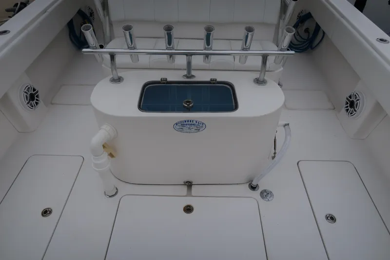 Slide: The Image of 2016 Invincible 42 Open Fisherman boat deck with rod holders and livewell. - 48