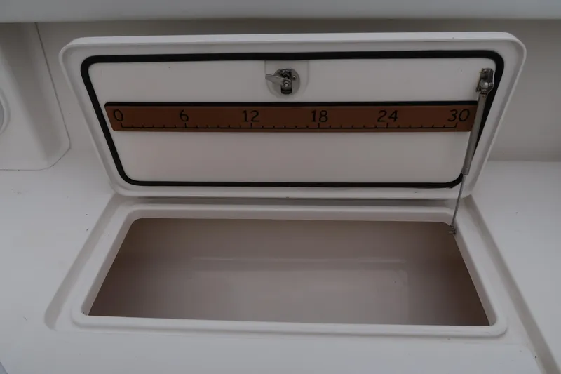 Slide: The Image of Open storage compartment with measuring scale on a 2016 Invincible 42 Open Fisherman boat. - 49