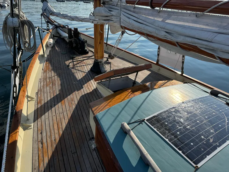 Slide: The Image of Sailboat deck of 1996 Custom John Alden Malabar II with solar panel and wooden finish. - 11