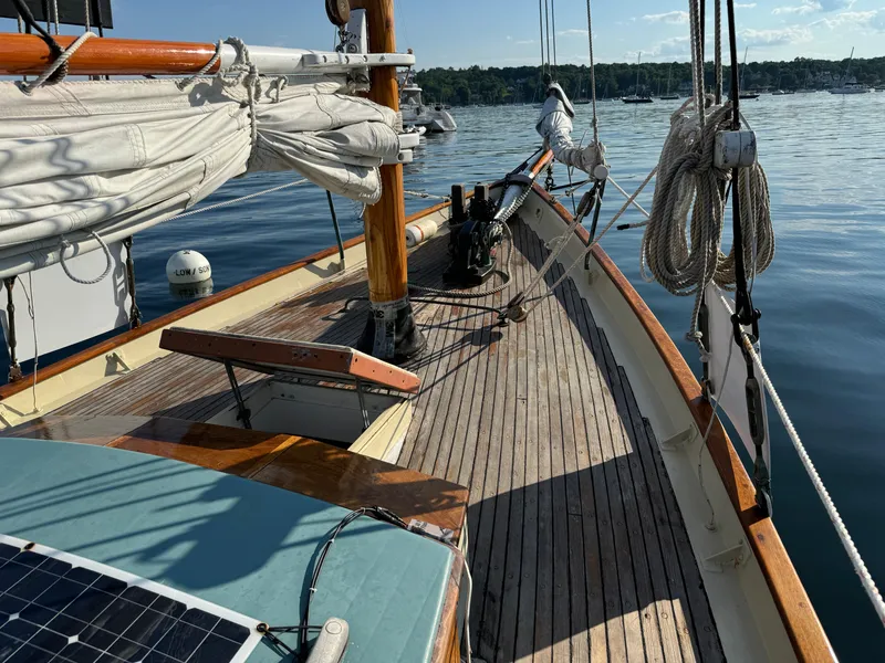 Slide: The Image of Wooden deck of 1996 Custom John Alden Malabar II sailboat on calm water. - 12