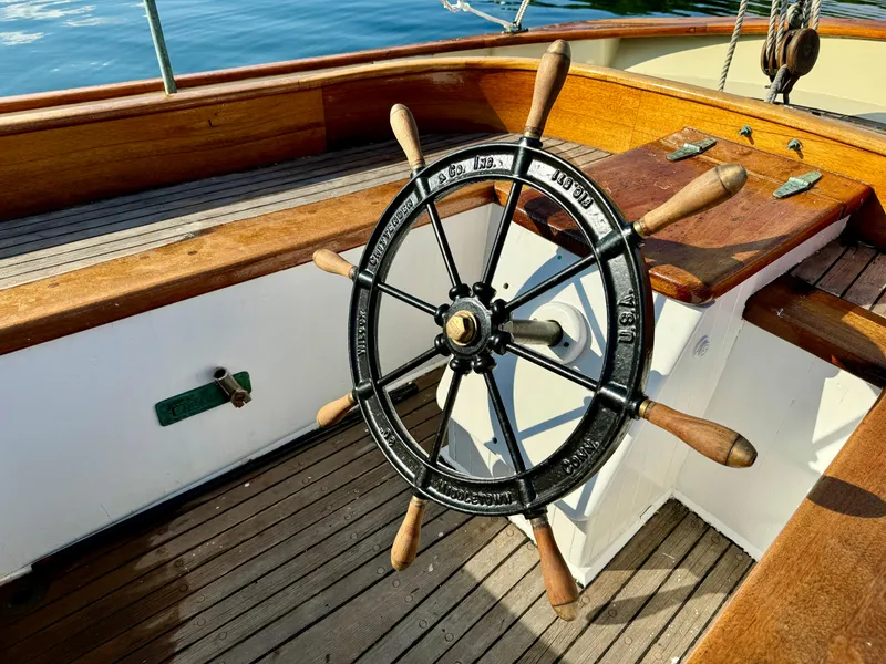 Slide: The Image of Wooden ship wheel on a 1996 Custom John Alden Malabar II sailboat deck. - 19