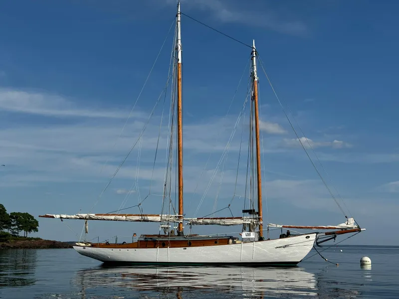 Slide: The Image of Sailing yacht "John Alden Malabar II" on calm water, 1996 model, clear sky background. - 2
