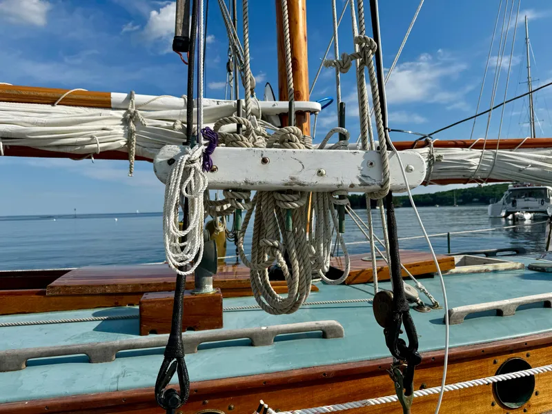 Slide: The Image of Sailboat rigging on a 1996 Custom John Alden Malabar II, with clear blue sky and calm water. - 21