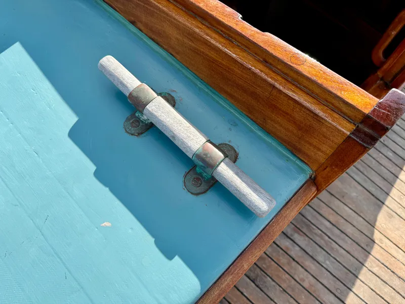 Slide: The Image of Wooden deck detail of 1996 Custom John Alden Malabar II sailboat with metal hinge. - 24