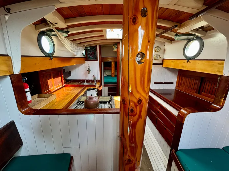 Slide: The Image of Interior of 1996 Custom John Alden Malabar II sailboat with wooden finishes and portholes. - 26