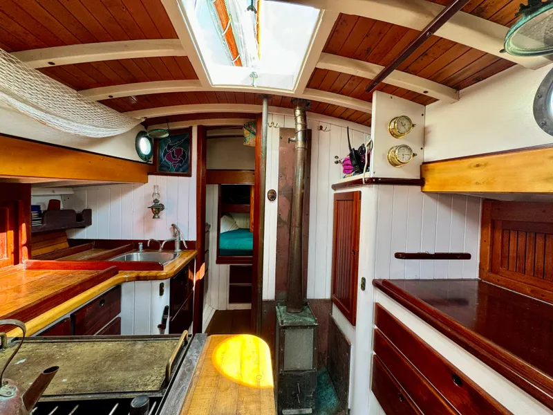Slide: The Image of Interior of 1996 Custom John Alden Malabar II sailboat with wooden cabinetry and cozy design. - 27