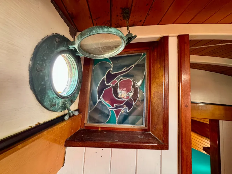 Slide: The Image of Stained glass window and porthole on 1996 Custom John Alden Malabar II boat interior. - 36