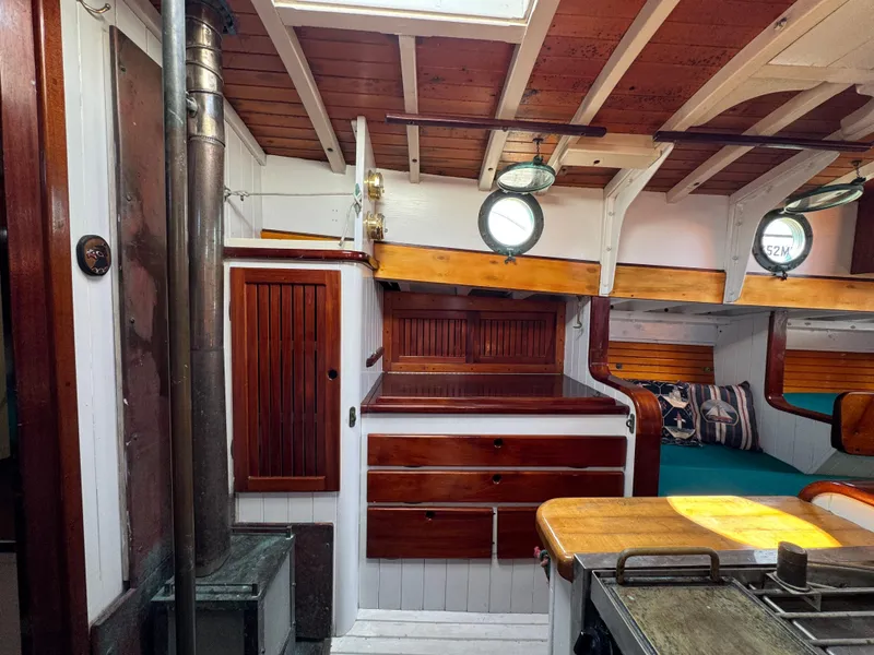 Slide: The Image of Interior of 1996 Custom John Alden Malabar II sailboat with wood paneling and cozy cabin. - 37