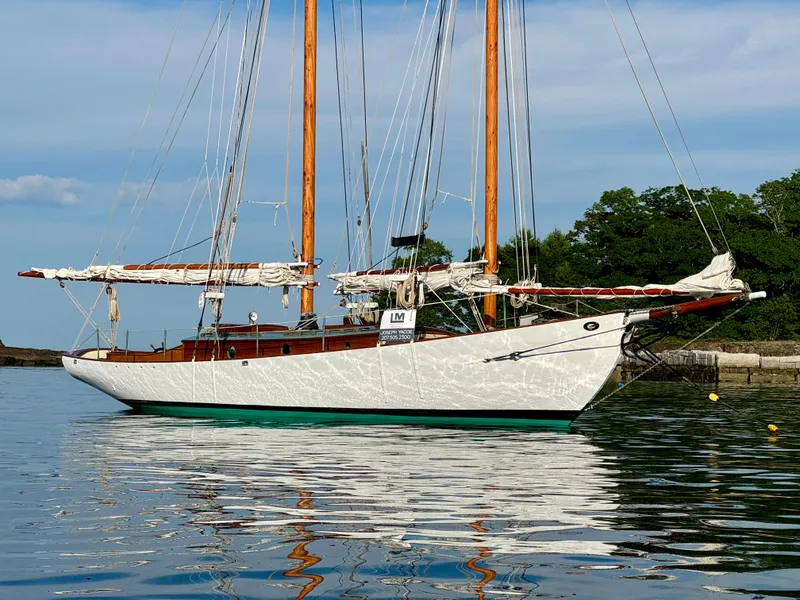 Slide: The Image of Classic 1996 Custom John Alden Malabar II sailboat on calm water, with lush greenery background. - 4