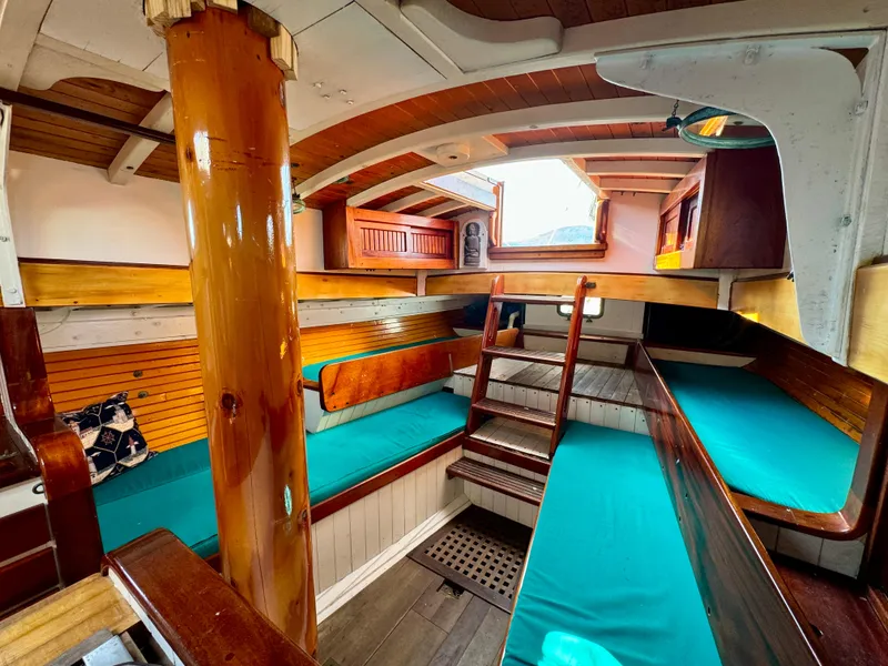 Slide: The Image of Interior of 1996 Custom John Alden Malabar II sailboat with wooden finishes and teal seating. - 43