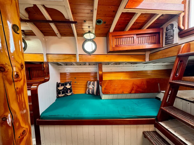 Slide: The Image of Cozy cabin interior of 1996 Custom John Alden Malabar II with wooden accents and teal bedding. - 45
