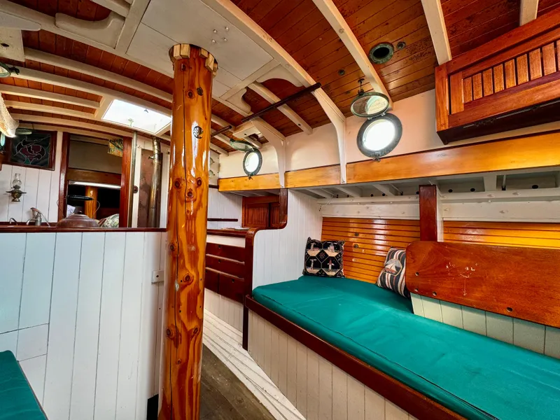 Slide: The Image of Interior of 1996 Custom John Alden Malabar II sailboat with wooden finishes and teal seating. - 48