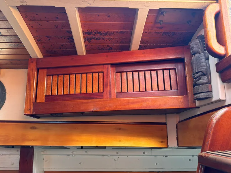 Slide: The Image of Wooden interior of 1996 Custom John Alden Malabar II boat, featuring detailed cabinetry and carvings. - 49