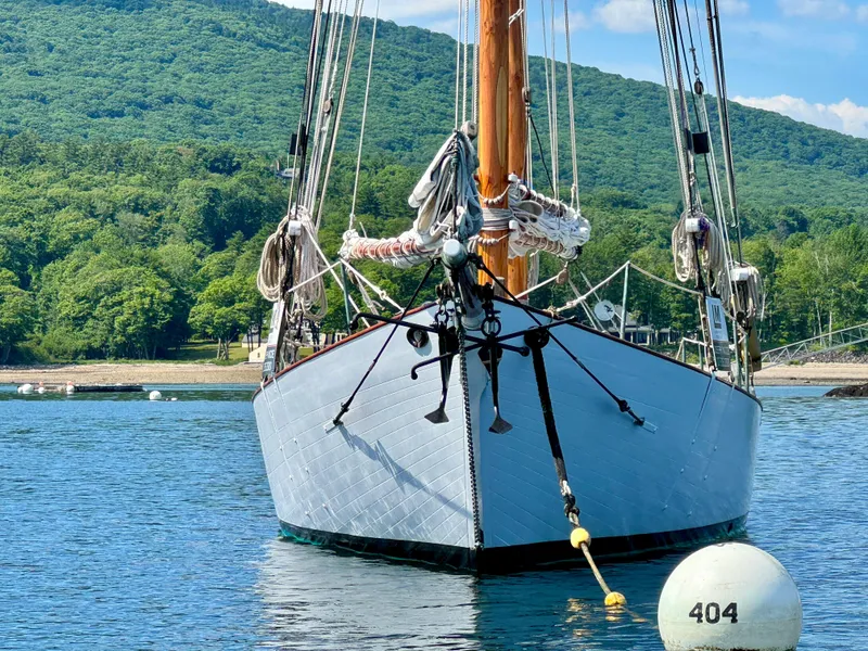 Slide: The Image of Front view of 1996 Custom John Alden Malabar II sailboat on calm water. - 6