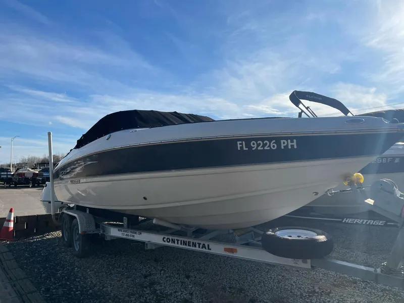 Slide: The Image of 2012 Stingray 225 LR boat on trailer under clear blue sky. - 11