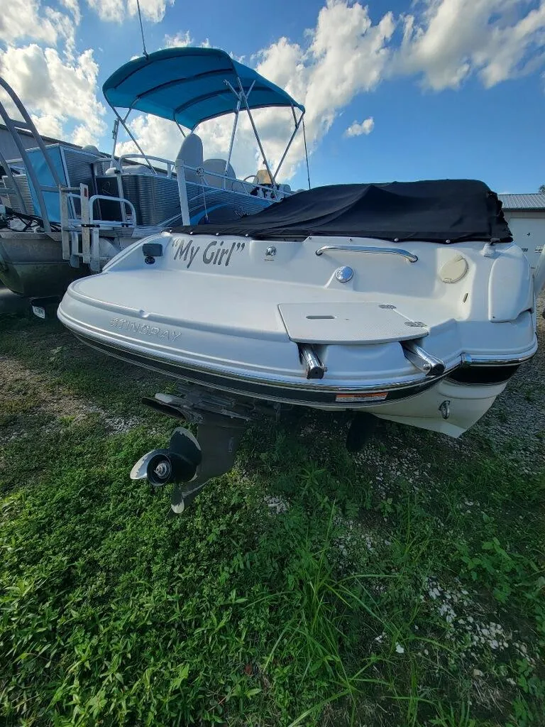 Slide: The Image of 2012 Stingray 225 LR boat named My Girl docked on grass. - 2
