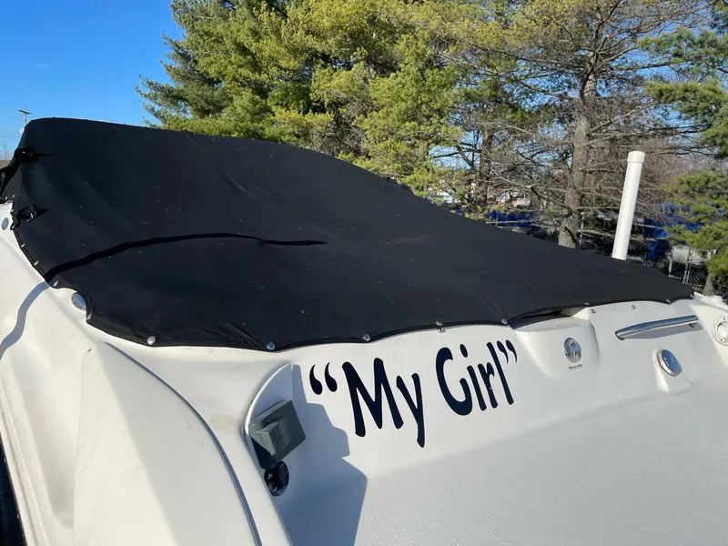 Slide: The Image of 2012 Stingray 225 LR boat named "My Girl" with black cover, outdoors. - 6