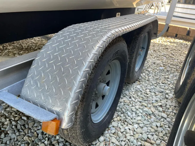 Slide: The Image of Trailer with diamond plate fender for 2012 Stingray 225 LR boat on gravel. - 7